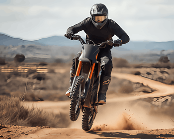 CEMOTO electric dirt bike with gold suspension performing a wheelie on a desert trail.