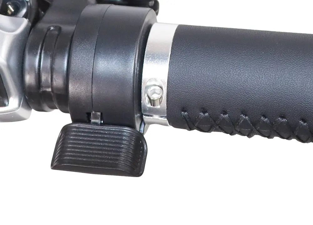 Black ebike thumb throttle mounted on handlebar with textured grip and silver clamp